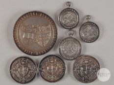 Seven silver athletics medals awarded to Guy Butler.