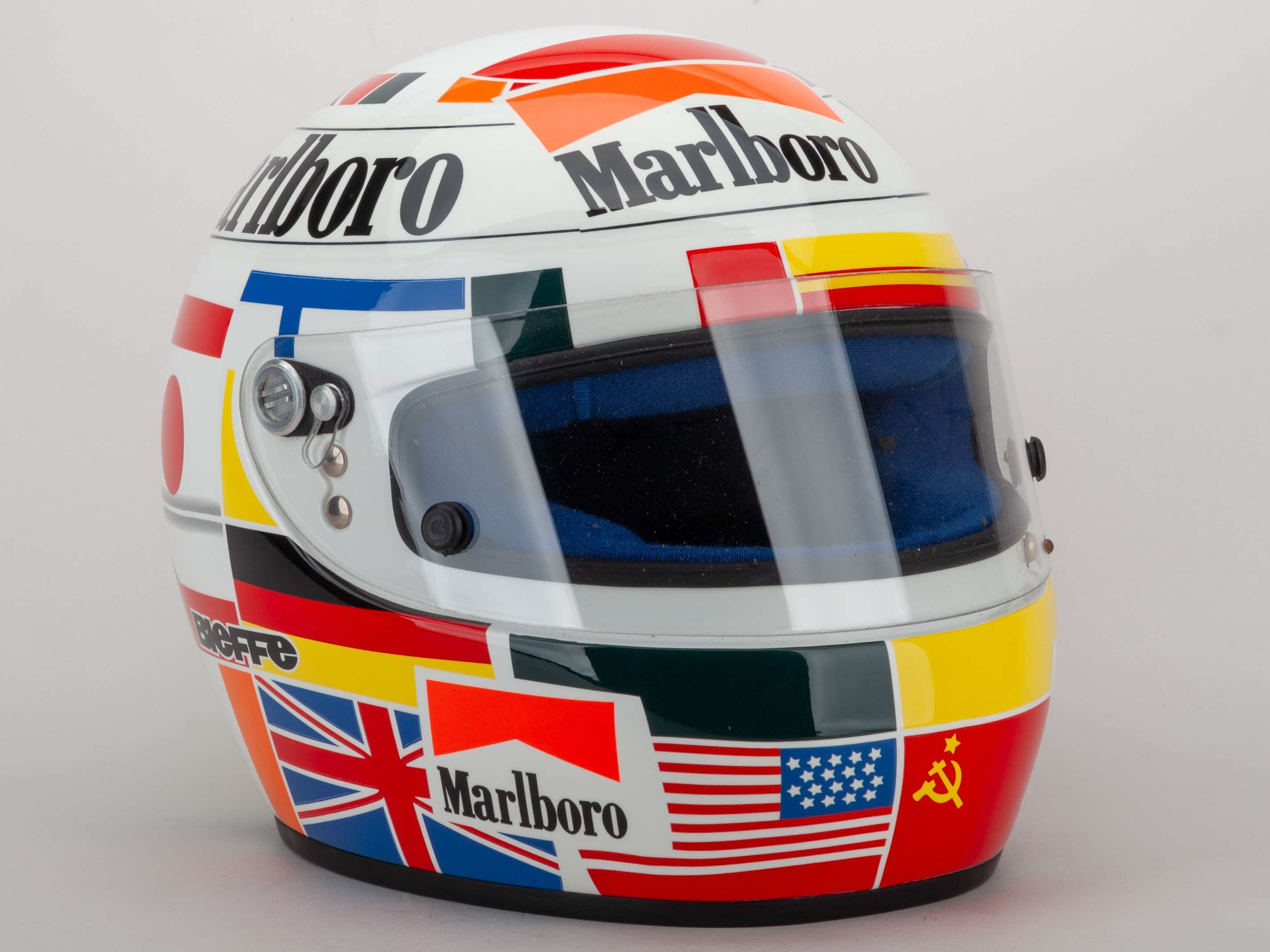 A Gerhard Berger Bieffe replica helmet with sponsors logos