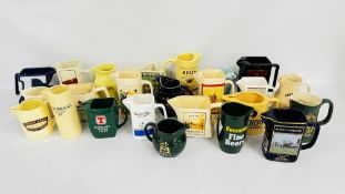 A COLLECTION OF 24 ASSORTED ADVERTISING PUB JUGS TO INCLUDE FAMOUS GROUSE, HEINEKEN,