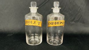 TWO VINTAGE CLEAR GLASS APOTHECARY TITLED 