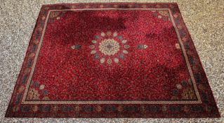 A LARGE PERSIAN CARPET, THE CENTRAL MEDALLION ON A PLUMB RED FIELD, 4.6M X 3.66M.