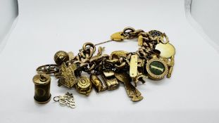 A 9CT GOLD CHARM BRACELET WITH 23 9CT GOLD CHARMS ATTACHED AND THREE FURTHER YELLOW METAL PLUS