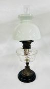 A VINTAGE OIL LAMP WITH A MOULDED CLEAR GLASS FONT AND WHITE GLASS SHADE.