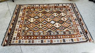 A PERSIAN FLAT WEAVE RUG, WOVEN WITH LOZENGE SHAPED MOTIFS IN DIFFERENT SHADES OF BROWN AND GREY 2.