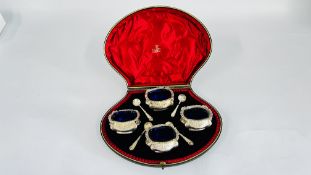 A CASED GROUP OF FOUR SALTS WITH BLUE GLASS LINERS,