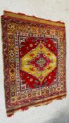 AN ORIENTAL RUG, THE CENTRAL STEPPED MOTIF ON A RED FIELD, POSSIBLY TURKISH 1.7 X 1.4M.