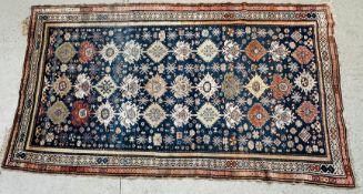 A PERSIAN RUG, THE MOTIF'S ON A BLUE FIELD, THE GUARD STRIPES WITH CRUCIFORM MOTIFS 3.2 X 1.67M.