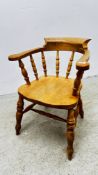 A BEECH WOOD ELBOW CHAIR.