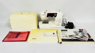 JANOME QXL 605 ELECTRIC SEWING MACHINE WITH EXTENSION TABLE AND INSTRUCTIONS - SOLD AS SEEN.