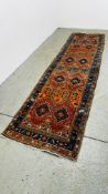 A C20TH PERSIAN RUNNER, THE HEXAGONAL AND STEPPED MOTIF'S ON A BRICK RED FIELD 35 X 91CM.
