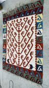 AN ORANGE / GREEN AND BLUE PERSIAN FLAT WEAVE CARPET WITH HOOKED MOTIFS 1.7M X 2.38M.
