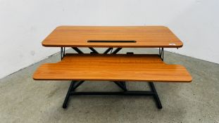A MODERN DESK MOUNTED ADJUSTABLE STANDING DESK ATTACHMENT.