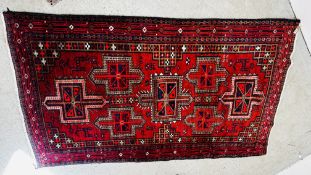 A CAUCASIAN RUG THE CRUCIFORM MOTIF ON A RED FIELD.