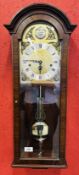 A GOOD QUALITY REPRODUCTION WALL CLOCK - COMITTI LONDON WITH BRASSED DIAL AND CHERUB DETAIL,