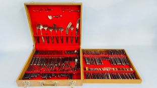A VINTAGE CASED CANTEEN OF BRASS FINISHED CUTLERY WITH WOODEN HANDLES.