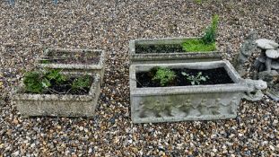 A PAIR OF LARGE STONEWORK PLANTING TROUGHS RELIEF DECORATED WITH DANCING FIGURES PLUS FURTHER PAIR