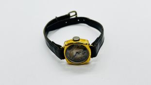 A VINTAGE 18CT GOLD CASED WRIST WATCH ON A BLACK LEATHER STRAP, MARKED J.W. BENSON.