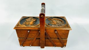 A VINTAGE OAK CANTILEVER WORK / SEWING BOX WITH CARVED PANELS L 41 X W 20CM X H 33CM INCLUDING