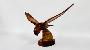 A CARVED LIMEWOOD SCULPTURE OF A KESTREL BY F. WOODLEY W 61.5 X H 37CM.