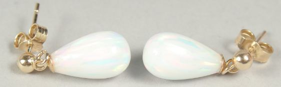 A pair of 9ct. gold opal tear drop earrings in a box.