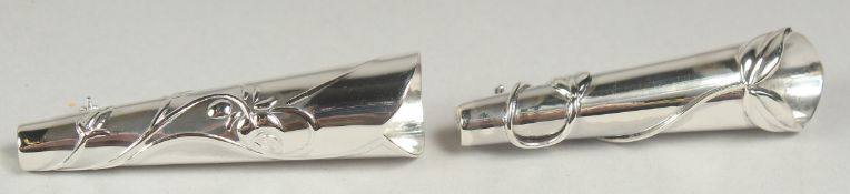 A pair of silver posy holder brooches in a box.