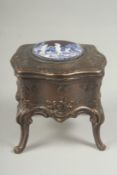 A small bronze trinket box with enamel circular pendant, 9cm wide.