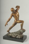 A SUPERB BRONZE ANATOMICAL MAN STANDING ON A ROCK, on a black marble base.11ins high.