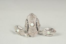 A silver opal set ring and earrings in a box.