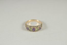 A 9CT GOLD SUFFRAGETTE'S RING, AMETHYST, PERIDOT AND DIAMOND RING.
