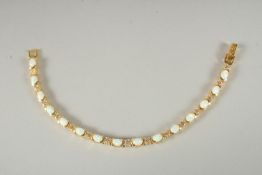 A SILVER GOLD PLATED, OPAL AND C Z LINE BRACELET.