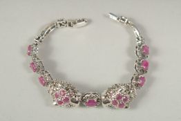 A silver real ruby double panther head bracelet in a box.