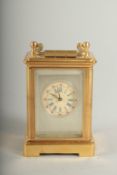 A MINIATURE CARRIAGE CLOCK with Sevres panel.6cm high.
