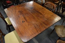 A 19th century mahogany tilt-top breakfast table with rounded rectangular top, turned column support
