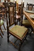 A set of five oak high back dining chairs, one with arms.