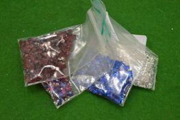 Various bags of coloured spinels.