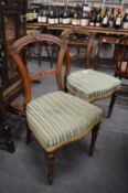 A pair of Victorian walnut dining chairs.