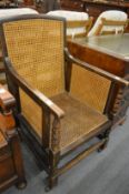 An oak framed bergere style armchair.