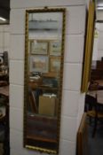 A gilt framed dressing mirror.