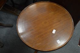 A mahogany circular tripod table (the base of a dumb waiter).