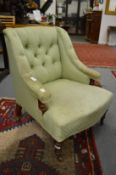 A Victorian button upholstered low armchair.