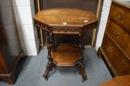 A Victorian walnut octagonal shaped two-tier centre table.