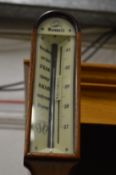 A reproduction mahogany ships stick barometer.