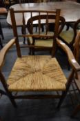 An ash and rush seated spindle back armchair.