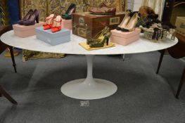 A large stylish oval white marble 'tulip' dining table with painted aluminium support.