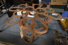 An unusual table base made from numerous horseshoes.