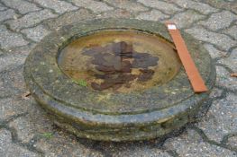 A circular bird bath top.