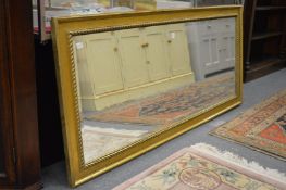 A large gilt framed rectangular mirror.