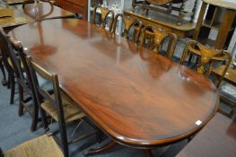 A good reproduction mahogany twin pedestal dining table with one leaf.
