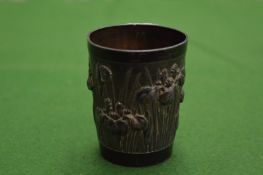 A small Chinese metal beaker.