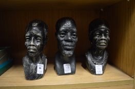 Three carved stone busts.